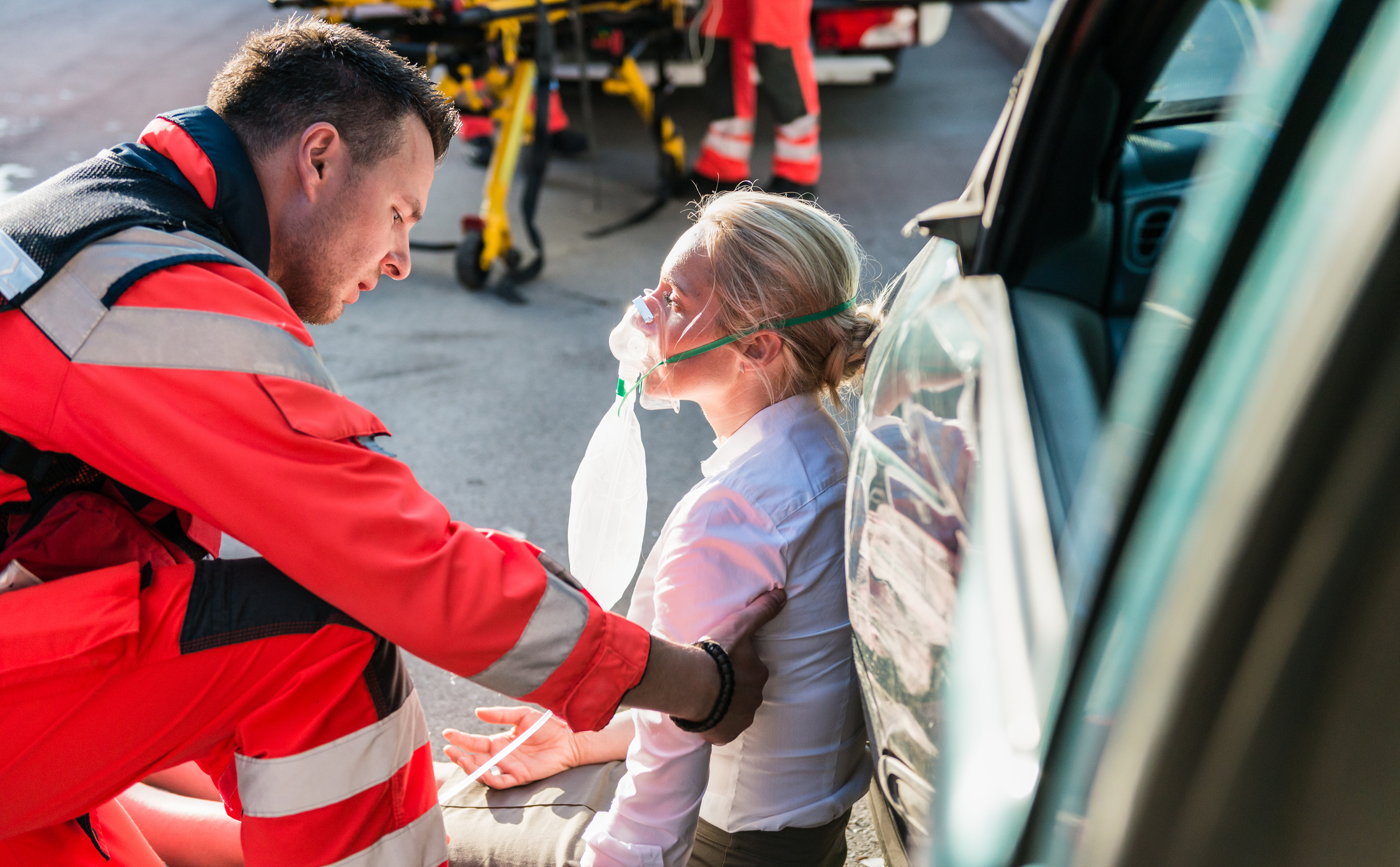 Male Paramedic Helping Injured Woman