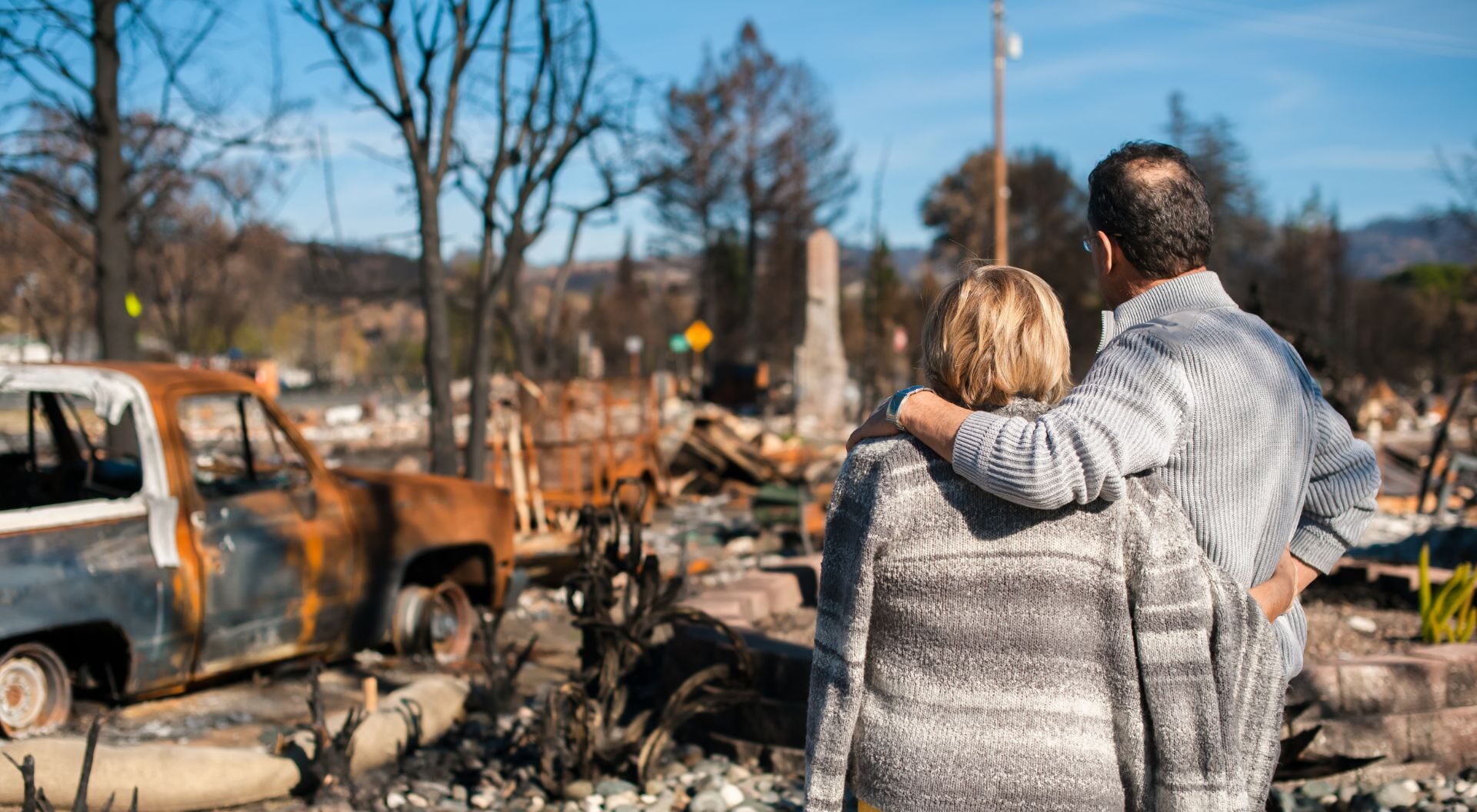 Couple surveys the damage after losing their home in a wildfire