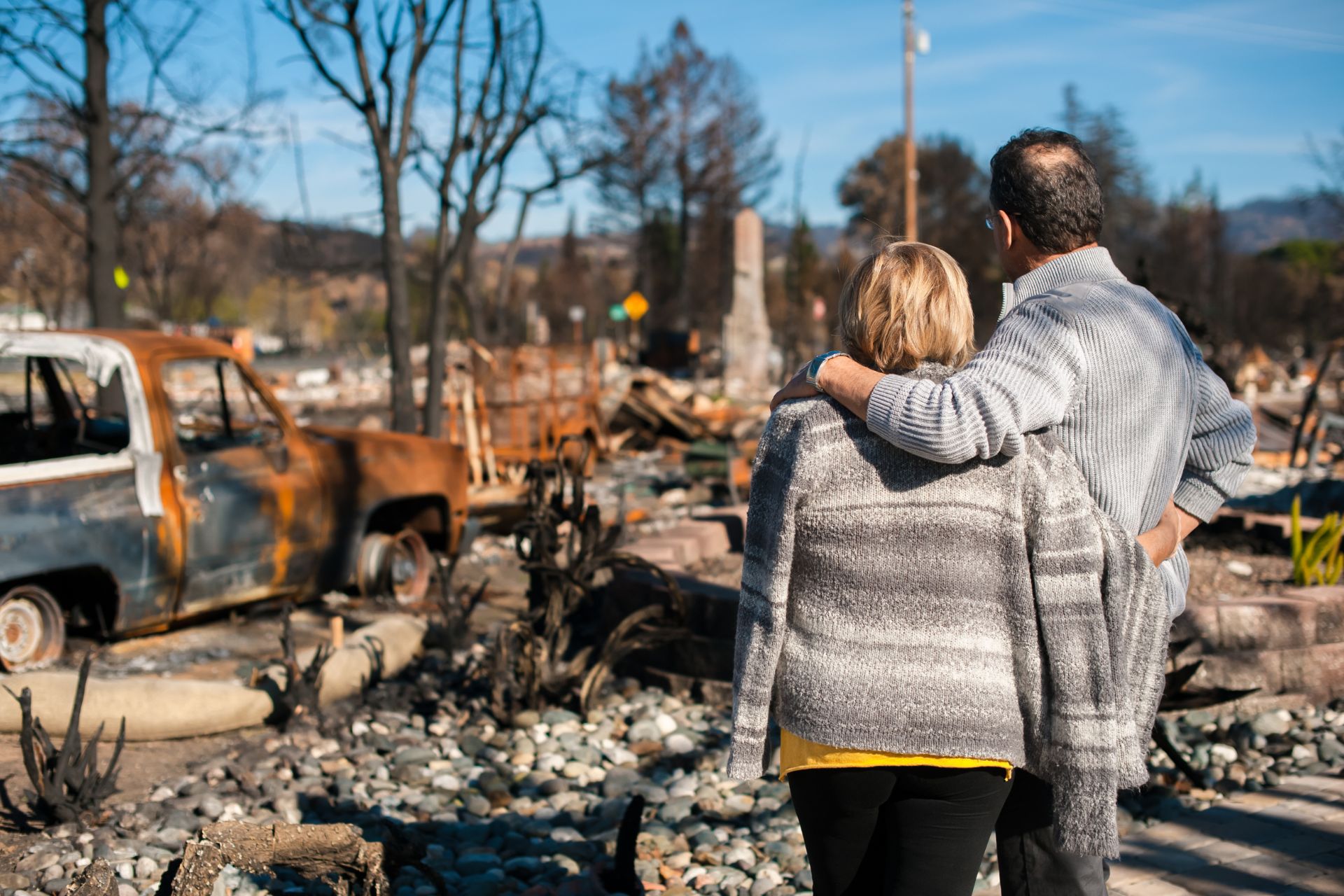 Couple surveys the damage after losing their home in a wildfire