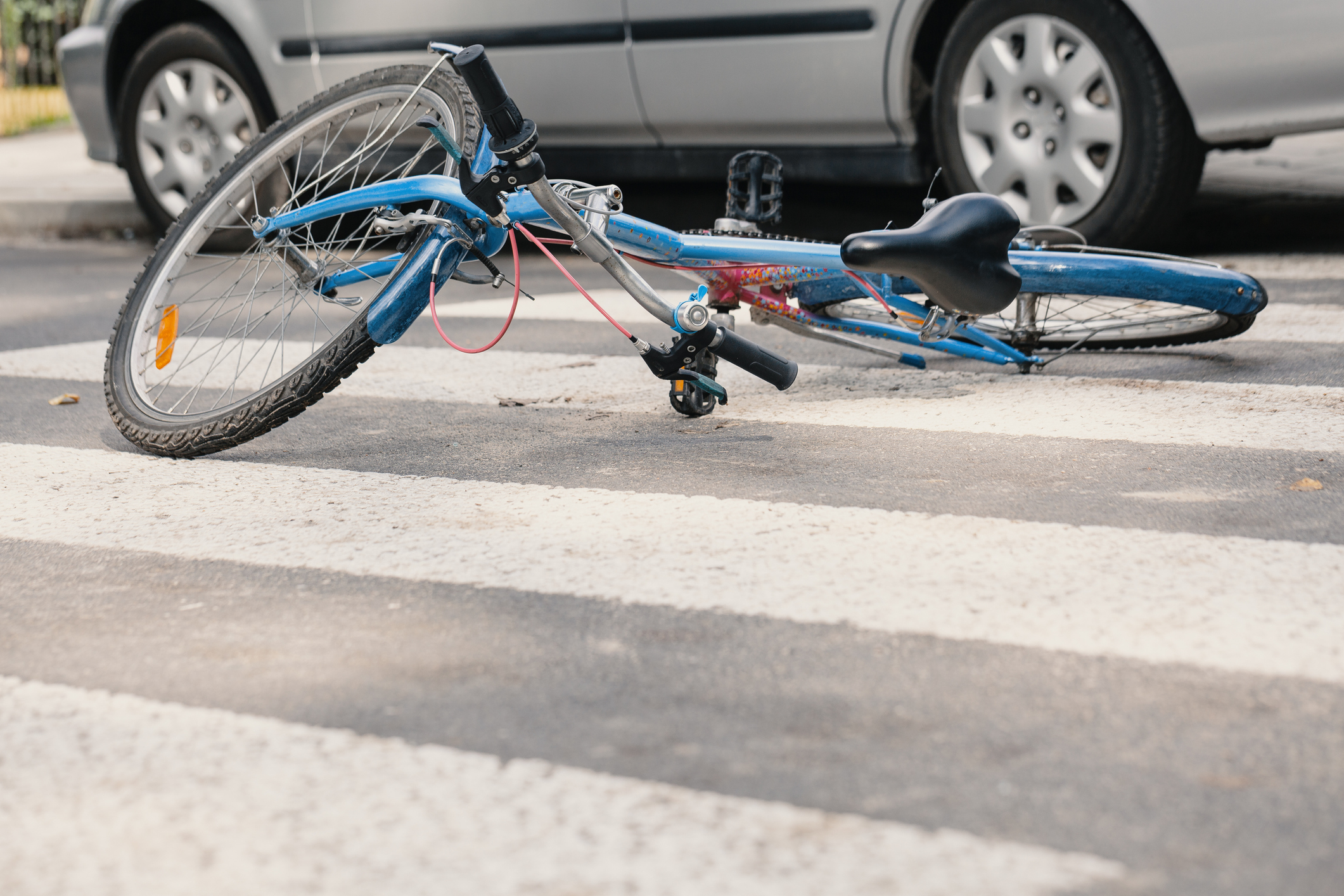 Aftermath of a bicycle accident with a car