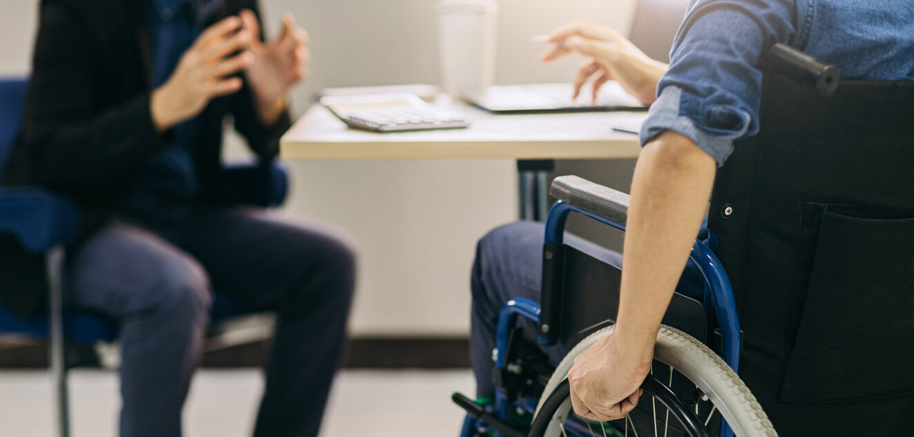 After accident and rehabilitation, a disabled man in wheelchair discusses legal options.