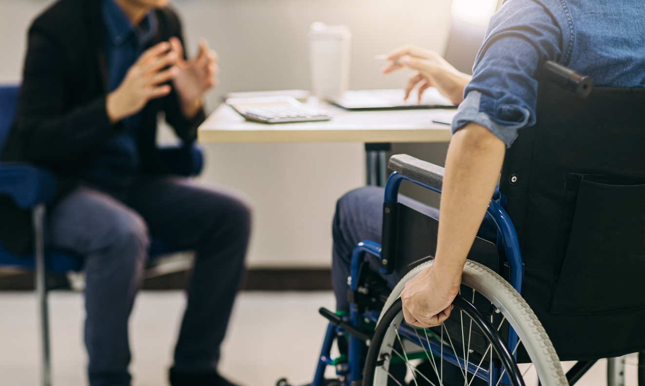 After accident and rehabilitation, a disabled man in wheelchair discusses legal options.