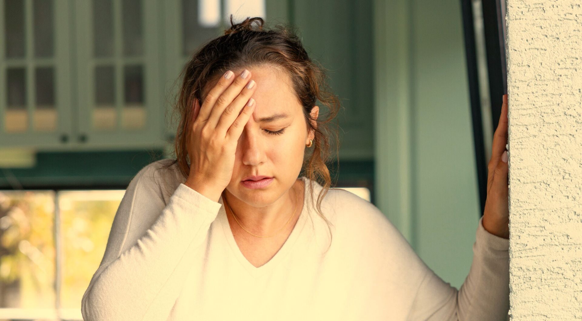 woman with a headache indoors due to smoke inhalation