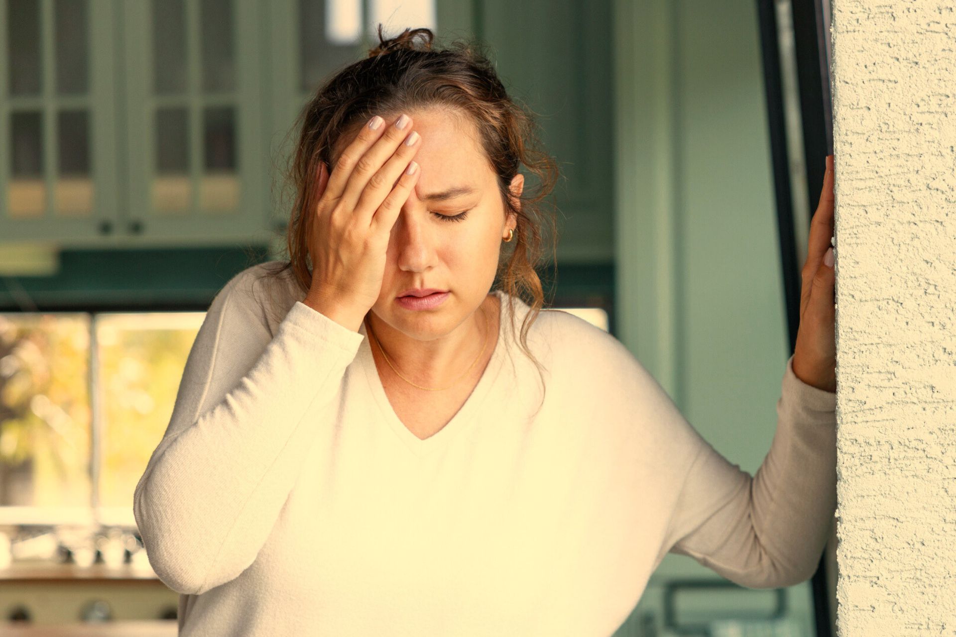 woman with a headache indoors due to smoke inhalation