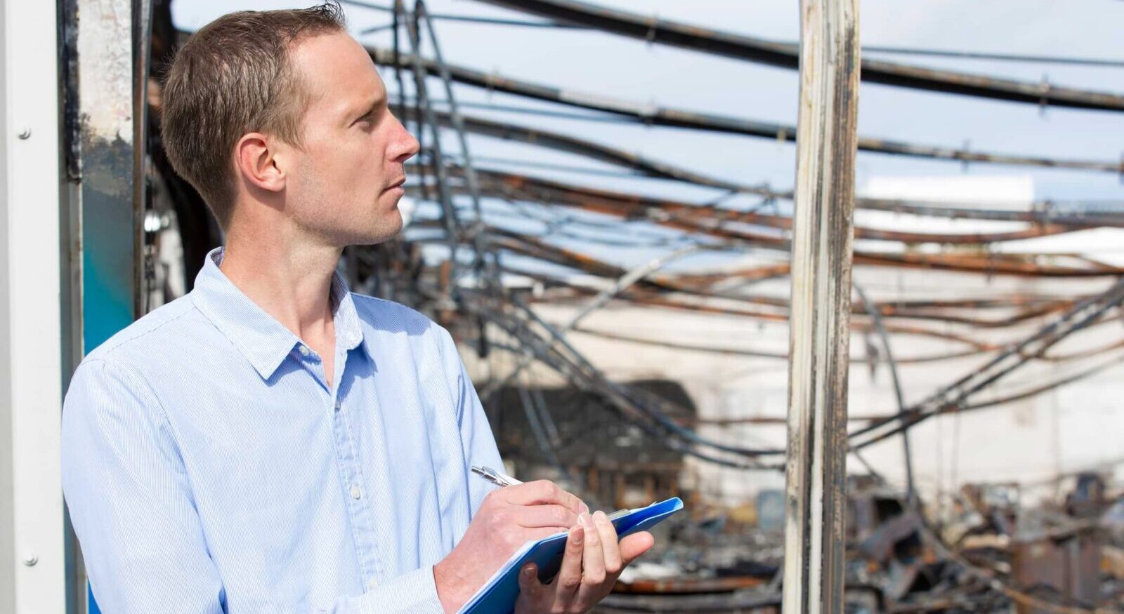 insurance adjuster assessing fire damage to a home