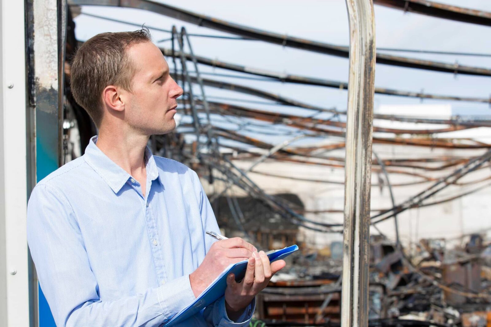 insurance adjuster assessing fire damage to a home