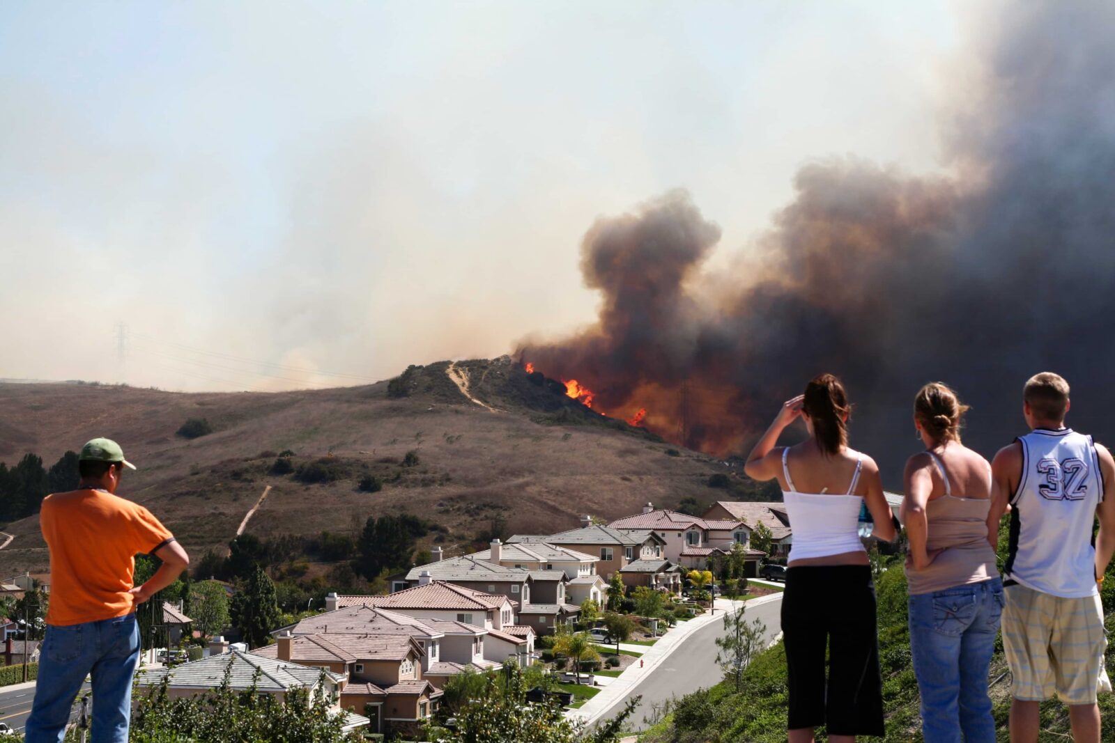 people watching brush fire near their homes