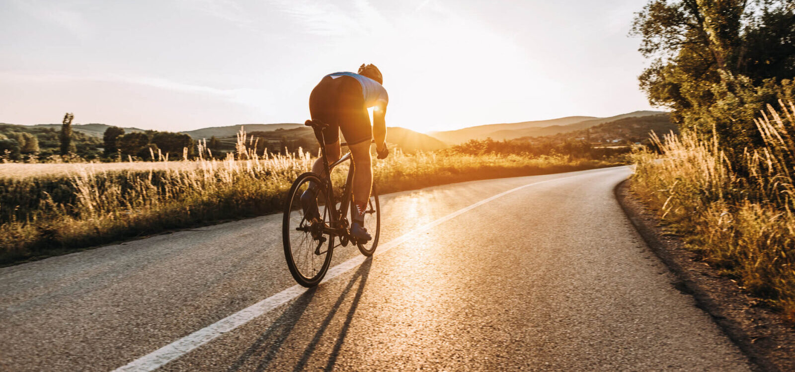 lone bicyclist training on the road