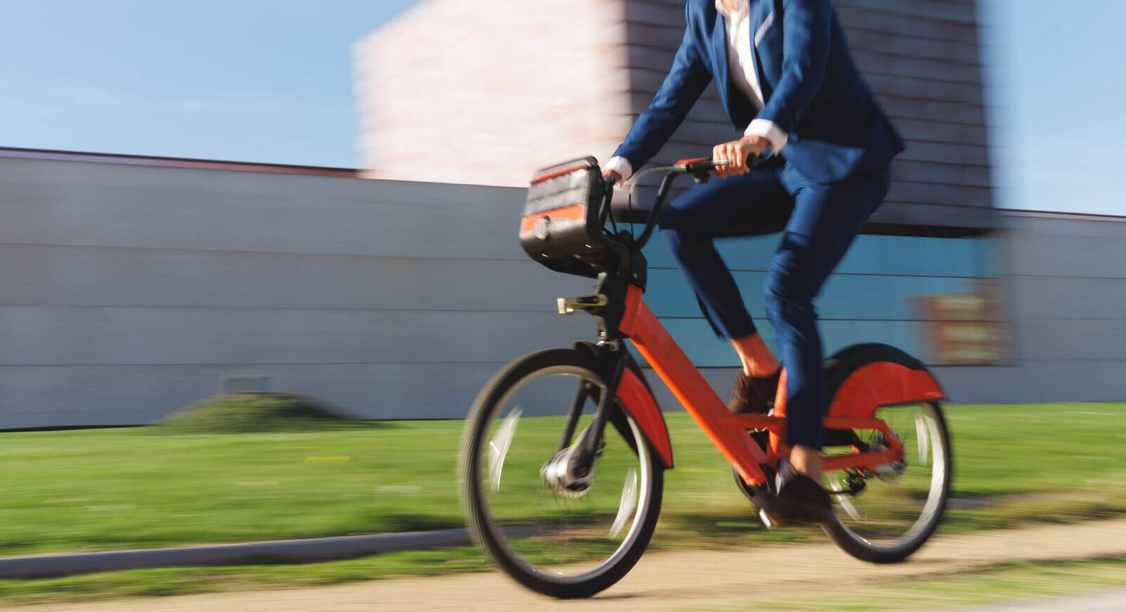 man in suit riding an e-bike fast