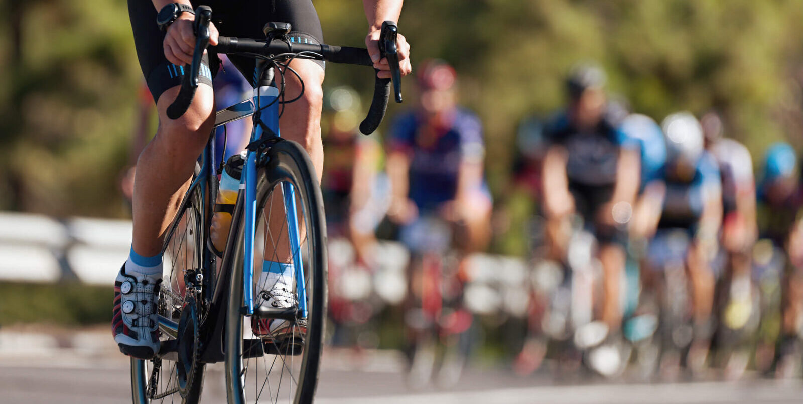 multiple cyclists riding in a bike race