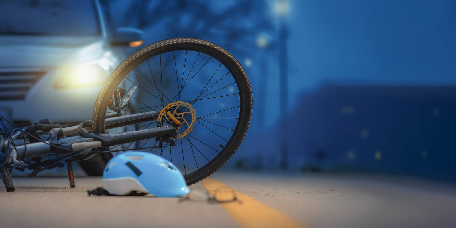 aftermath of a bike collision with car at nighttime