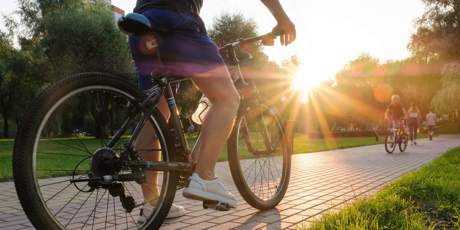 biking on paved path at a local park