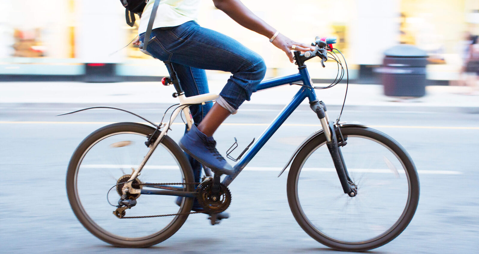 Cyclist riding bike through the city