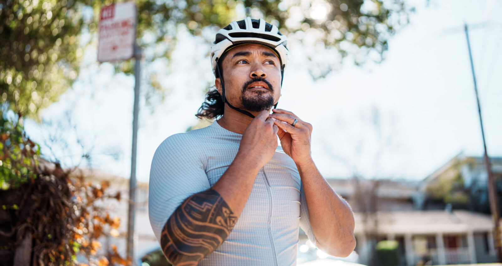 man putting on bike helmet before a ride